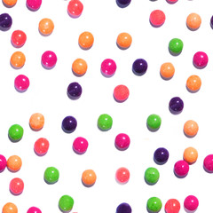 Colorful seamless texture pattern of multi colored sweet candy dragees. Round Bonbons scattered on a white background. Decorative Holiday Web banner. Beautiful Festive Wallpaper.