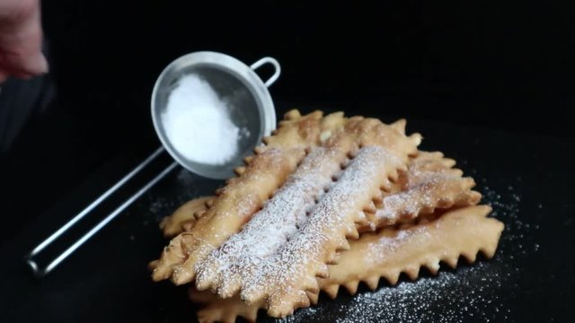 Carnival fritters topped with icing sugar, a typical Italian sweet of Carnival celebrations.