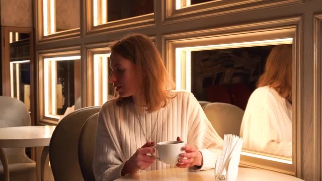 Beautiful Woman Is Drinking Coffee Outside. A Girl Is Drinking Tea Cafe