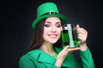St. Patrick's Day. Beautiful woman wearing green hat with beer