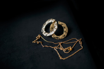 earrings and necklace on black background