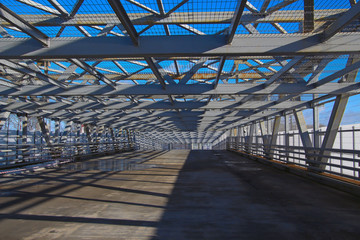pedestrian bridge of iron beams under the open sky