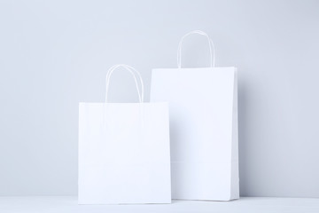 Fototapeta White shopping bags on grey background obraz