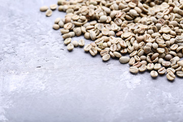 Green coffee beans on grey wooden table