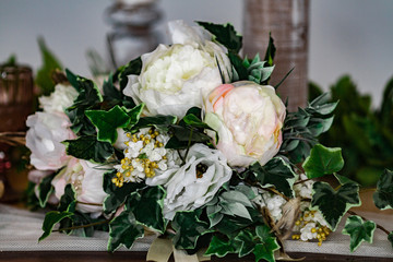 Delicate wedding bouquet of peonies with ivy leaves