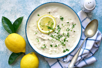 Avgolemono - traditional greek chicken soup with orzo pasta, eggs and lemon.Top view with copy...