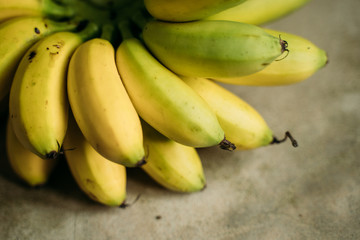 fresh mini bananas on the grey background