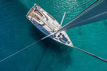 Top view of sailing boat anchored in the shallows