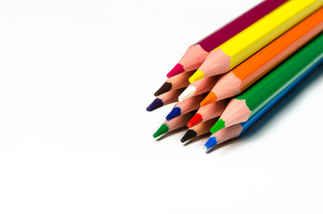 Colourful sharp pencils lie on a white background