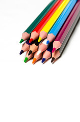 Fototapeta premium Colourful sharp pencils lie on a white background