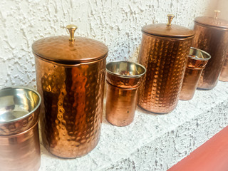 A Row of Indian Coppy Coiffee Pots and Cups
