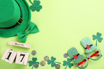 St. Patrick's Day. Green hat with clover leafs, wooden calendar, coins and glasses