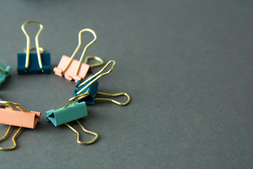 Colorful binder clips isolated on gray background, work space, work table, copy space.