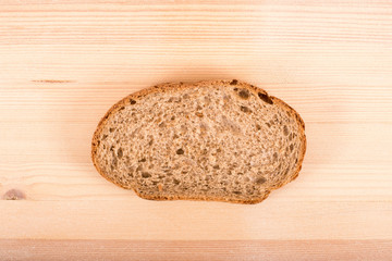 A piece of bread on a wooden table