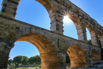 Aqueduct Pont du Gard with sunburst, southern France