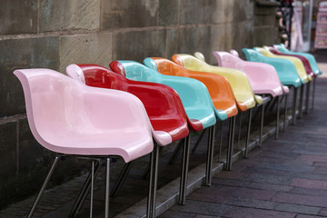 Contrasting colored plastic seats in the pedestrian area of Paderborn.