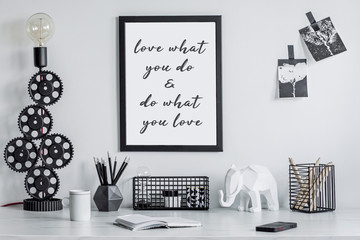 Modern and stylish black and white home decor mock up. Creative desk with blank picture frame or...