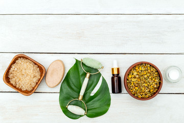 Clean beauty. Facial Roller on wooden background. Copy space