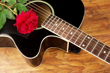 Acoustic guitar and red rose