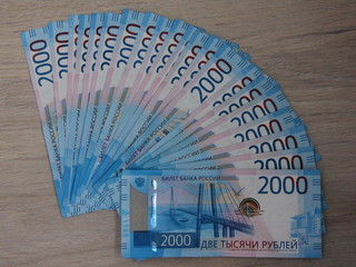 Money - new banknotes 2000 Russian rubles on brown background
