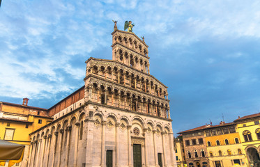 Fototapeta na wymiar Facade of Chiesa di San Michele in Foro St Michael Roman Catholic church basilica on Piazza San Michele square in historical centre of old medieval town Lucca, evening view, Tuscany, Italy
