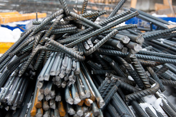 Billets of reinforcement at the construction site. Construction of the building with the help of...