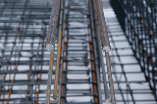 Billets of reinforcement at the construction site. Construction of the building with the help of reinforced concrete. Reinforcement of concrete base.