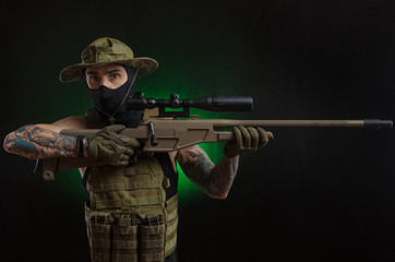 The guy in protective clothing and a black mask with a sniper rifle