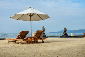 Beach lounge chairs with umbrella on the beach