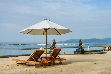 Beach lounge chairs with umbrella on the beach