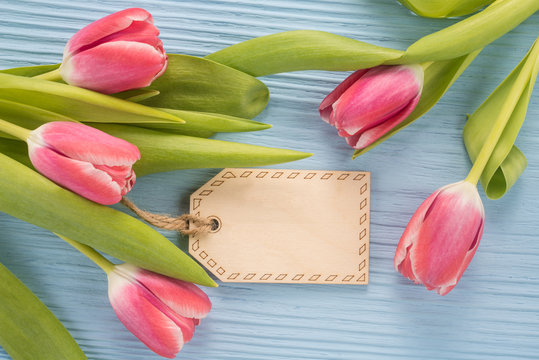 Fresh pink tulip flowers on  wooden background 