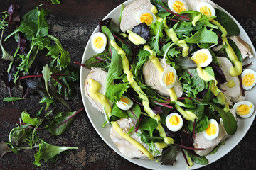 Healthy salad with quail eggs, salad mix and chicken breast. Keto diet. Paleo. Pegan