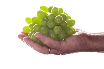 Man hand holding a bunch of green grapes, Isolated on white background.