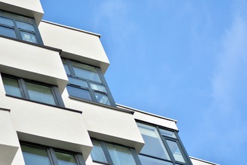 Modern white building with balcony on a blue sky
