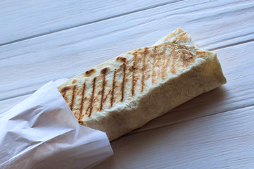The girl's hair is white. eats shawarma. Fast food.
