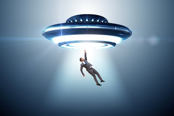 Flying saucer abducting young businessman 