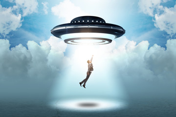 Flying saucer abducting young businessman  © Elnur