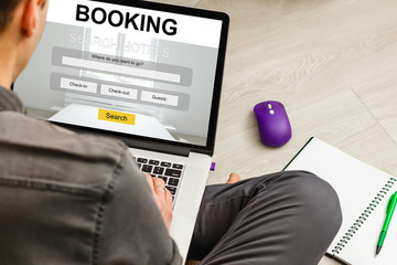Businessman reserves a hotel room. Working on a laptop. Book online.