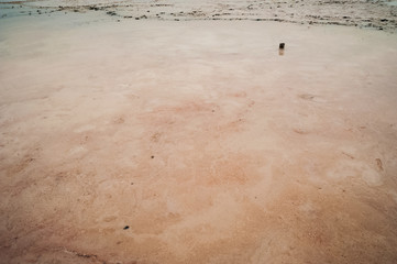 Beautiful natural textural background on a salt lake, river. Salt lake Elton, Russia, before rain and thunder, sunset on the water, solitude, silence, calm
