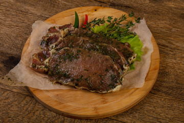 Raw marinated pork steak