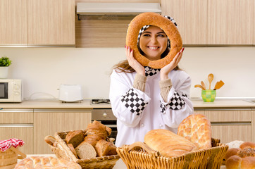 Young female baker working in kitchen 