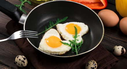 Fried eggs in the form of a heart in a skillet