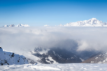 Mont Blanc mountain above the clouds. View from ski resort La Plagne in Savoy Alps, France
