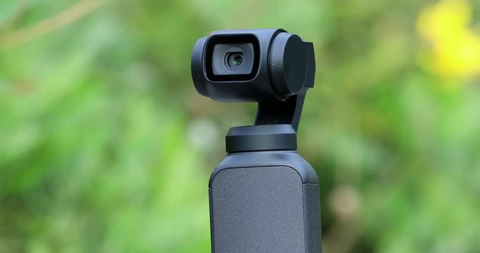 Closeup Of Small Gimbal Camera, Head Automatically Tracks The Subject, Green Nature Background - DCi 4K Video