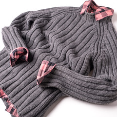Fototapeta na wymiar Gray wool sweater and checkered pink shirt on a white background.