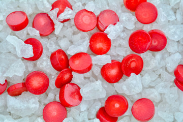 Red Coral Beads on Crystals of Bath Sea Salt for Spa as Summer background