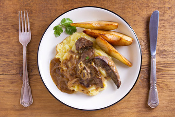 Beef liver with pears and mashed potato. View from above, top studio shot