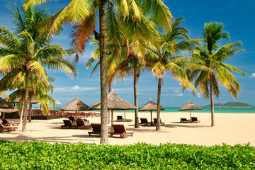 Many empty sun loungers on the deserted beach of Hainan Island.