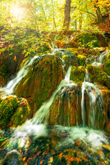 Fototapeta na wymiar small waterfall in autumn forest