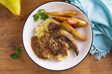 Beef liver with pears and mashed potato. View from above, top studio shot